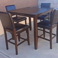 Brown Wooden dining table with 4 matching faux leather chairs 36" T x W x 39"1/ x 39" 1/2  NO DELIVERY  Will NOT  Separate The Set !