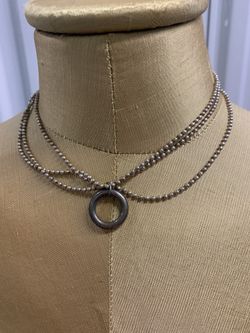 Silver tone necklace with ring detail and 3 strands