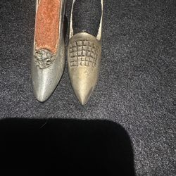 Two brass or silver shoe pin cushions