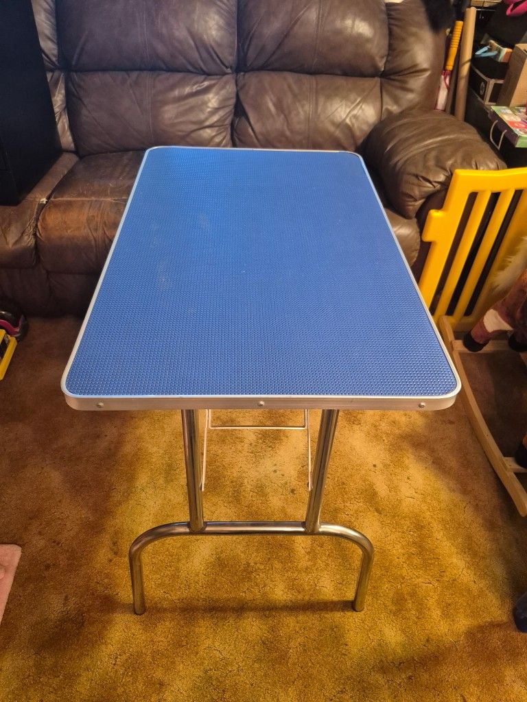 Medium Sized Metal folding Table. Very strong 20 by 32. Height 29. Hard rubber blue top. Folds easy.
