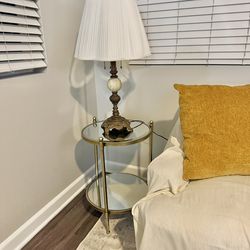 Round two tiered mirrored antique brass toned side table.