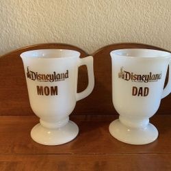 Pair of vintage milk glass footed Disneyland Mom & Dad Mugs - just under 5.25” tall