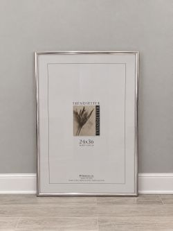 $10 - Polished silver-tone MCS Industries Trendsetter frame measuring 24 x 36 inches.  The back of the frame has multiple turn-clip fasteners and inte