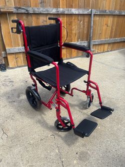 Wheel chair lightweight transport w hand brakes brand new pickup only
