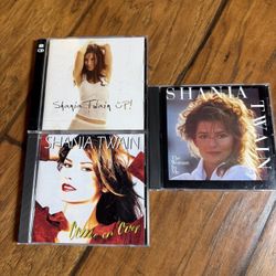 A collection of Shania Twain CD albums, specifically Up!, The Woman in Me, and Come on Over 3 Cd’s  Very good condition