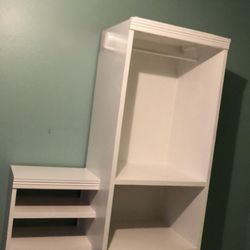 white shelving/display unit or cabinet with open cubbies):