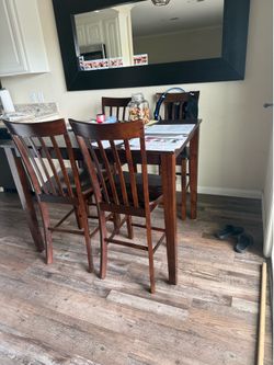Brown bar top table with 4 chairs