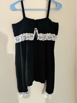 Black lace trip babydoll top with white lace trim at the neckline and hem
