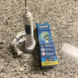 Oral-B electric toothbrush with charger plus a pack of 7 Precision Clean brush heads .