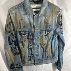 The Off-White c/o Virgil Abloh Graffiti Denim Jacket is a sought-after piece from the 2013–2020 era, often featuring the brand's iconic "Main Label" b