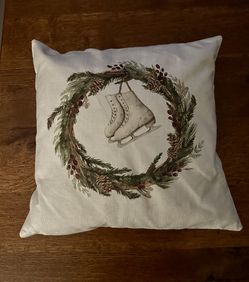 Decorative pillow with wreath and ice skate 