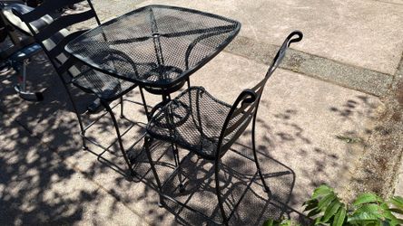 Wrought iron bistro table and chairs.