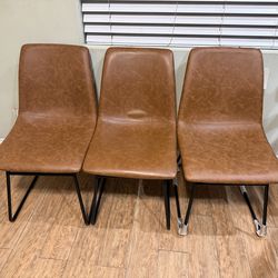 set of 3 faux leather dining chairs with black legs