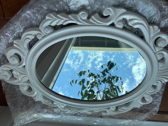 White ornate oval wall mirror
