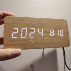 Digital clock with wooden frame, featuring 4 different styles 