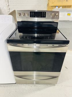 Kenmore stainless steel stove with a receipt for a 90-day warranty