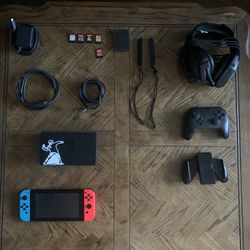 Nintendo Switch With Headphones, Controllers, And Games.