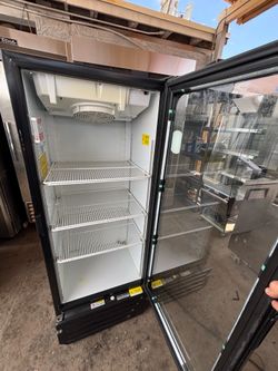 Glass-door refrigerator in perfect condition. It features modern lighting and is very clean, both inside and out.