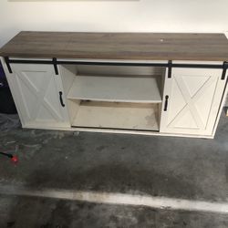 Farmhouse TV Stand with Sliding Barn Doors and a wood-look top. 