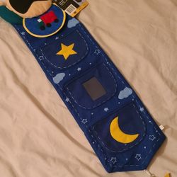 NEW Pic-a-pocket wall hanging for baby boy. A couple of pockets and a place for his picture. Measures 11.5 x 2.5 x 40 East, west, north  $15
