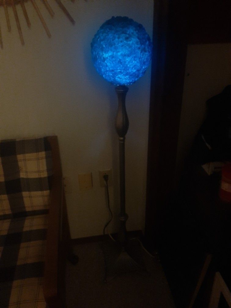 Antique Floor Lamp with a thick blue chip glass globe.