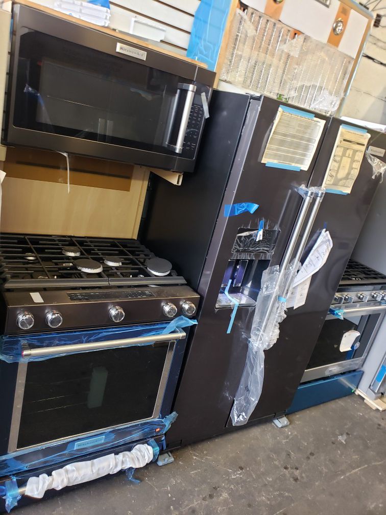black stainless 3 peace set ,,slide in convention stove..fridge and microwave..top of the line,,kitchen aid,, best item in appliances..only..2999