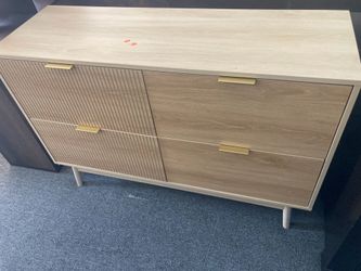 4-Drawer Wood Dresser featuring fluted detailing on the left drawers and sleek gold metal handles.