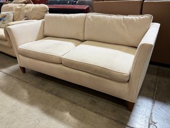 Beige and Cream Corduroy Low Back Loveseat with Dark Wood Feet