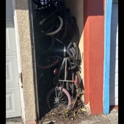 side yard full of bikes atleast 20 bikes 