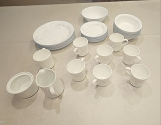 Corelle 39 peice set of dishes.
9 Big plates, 10 Small plates, 9 Bowls, 8 mugs with handles, 1 Serving Bowl, 1 Sugar container and 1 cream container