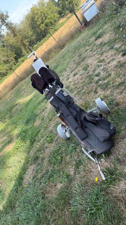 complete Pro Kennex GVS iron set bundled with a golf bag and a pull/push cart