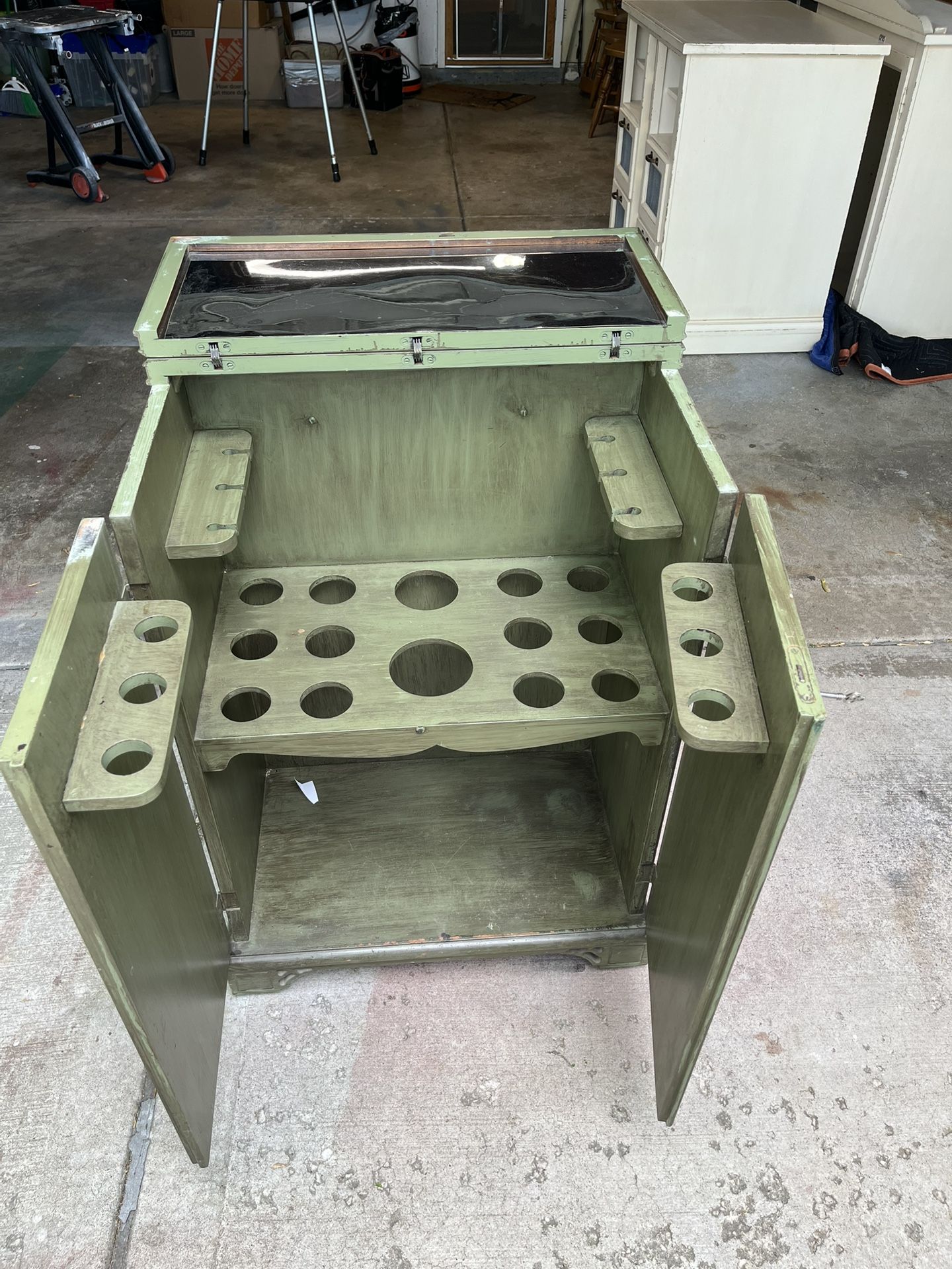 Repurposed vintage bar cabinet for storing organizing bars & bottles painted in distressed green This unit is on wheels and comes with key. Please wa