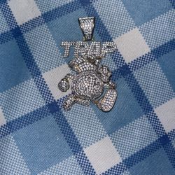 “Trap” Iced out golden chain pendant.