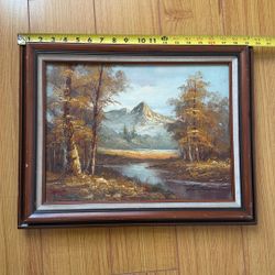 oil-on-canvas-board depicting an alpine mountain scene. The signature in the lower right looks like it may read something similar to “T. Whitman”