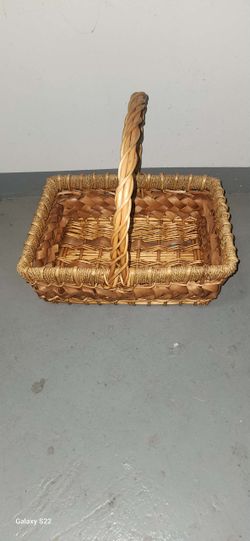 rectangular wicker basket with a braided handle.