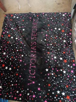 Victoria's Secret Plush Sherpa Throw Blanket featuring a black starburst pattern with pink and red accents.