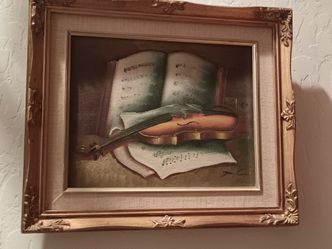 Antique canvas painting and violin. That holds  artificial flowers