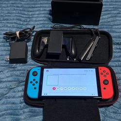 NINTENDO SWITCH OLED WITH CHARGER, DOCKING STATION, JOYCON GRIPS AND CASE  NO TRADES CASH ONLY NO HOLDS. 