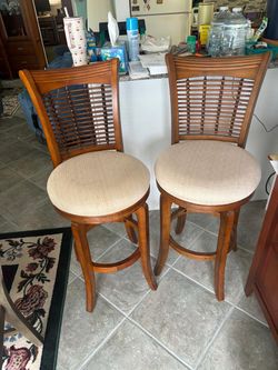Two solid wood bar stool  chair, and swirl .. 18” around , 46” high to top , 29” high to chairs $150 both
