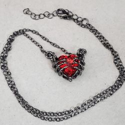 Gunmetal Grey Skeleton Hands With Bright Red Heart Goth Halloween Necklace 