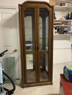 Cabinet with glass shelves and light