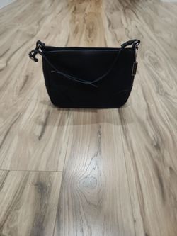 A bag with a tag that reads "COACH"