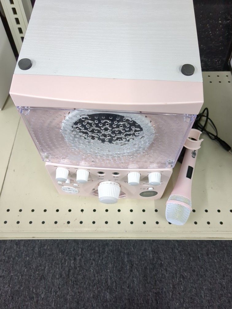pink portable karaoke machine, likely designed for kids or adults seeking a compact and fun entertainment system.