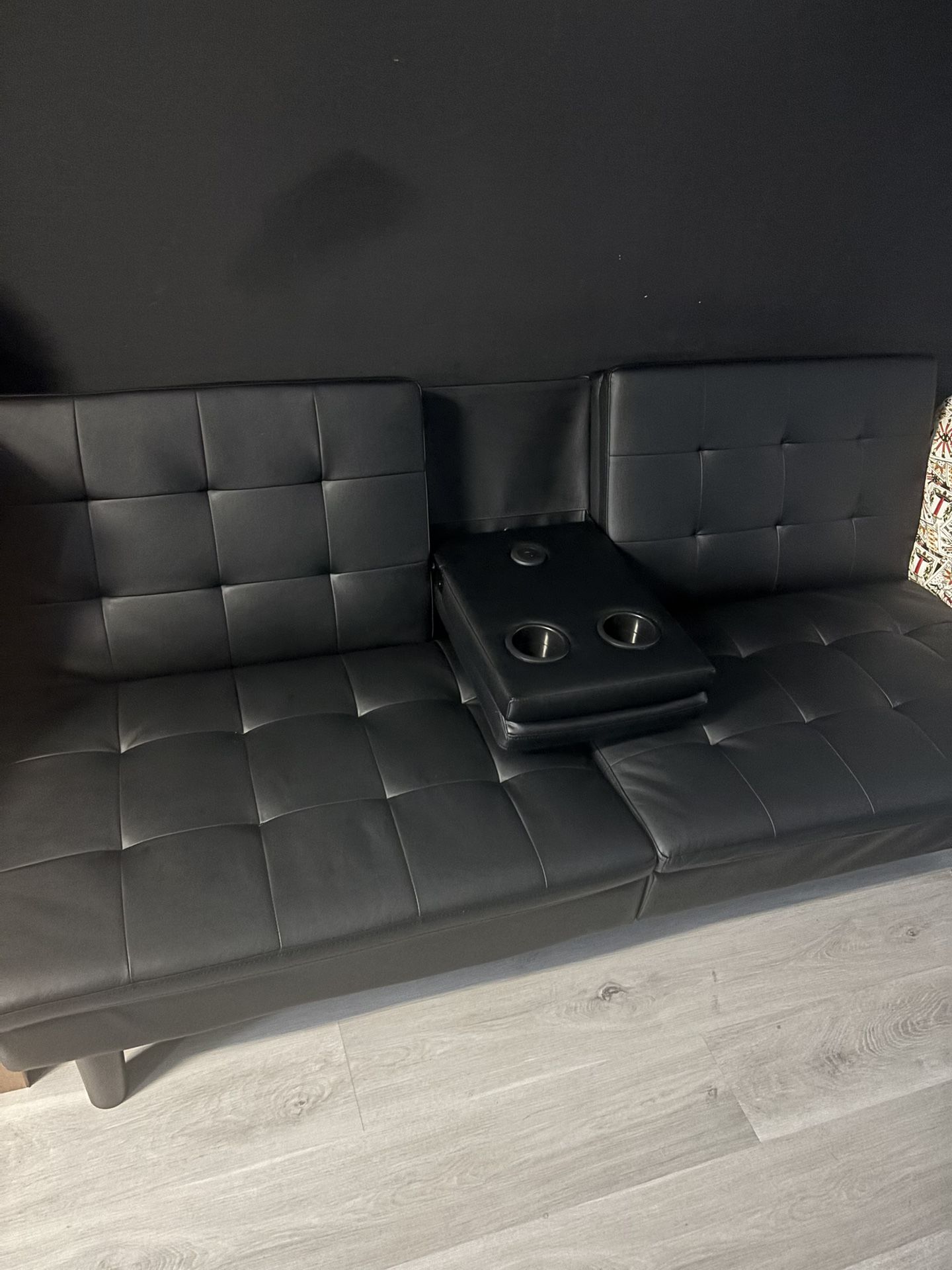 All Black Leather Futon With Two Cup Holder And A Charging Port