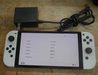 Nintendo Switch OLED Model HEG-001 Handheld Console - White W JOY CONS AND CHARGER USED . TESTED. IN A GOOD WORKING ORDER. F(contact info removed)0.