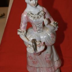 Victorian porcelain lady statue about 8 inches tall, golden pink