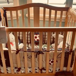 Baby Crib including changing table and a swing.