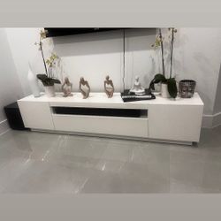 White TV stand with built in light. three cabinets offer a los of storage space for gamers or books Overall dimension: 78.75"W × 14.6"D x 17"W