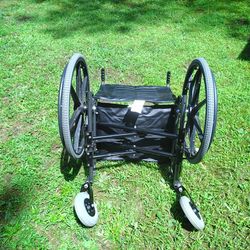 The image shows an Invacare Tracer IV Wheelchair. This is a heavy-duty wheelchair designed for active individuals needing a strong and durable mobilit