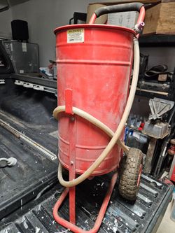 Portable sandblaster and 2 bags of black diamond blasting sand.